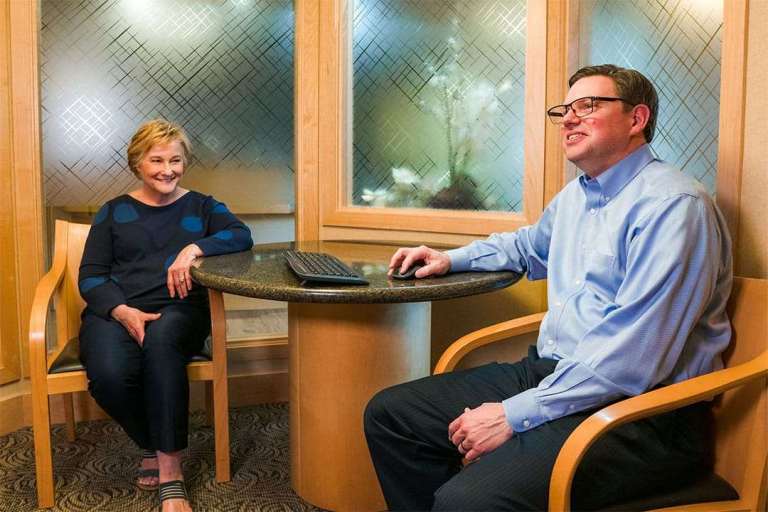 Patient visiting with dentist in waiting room